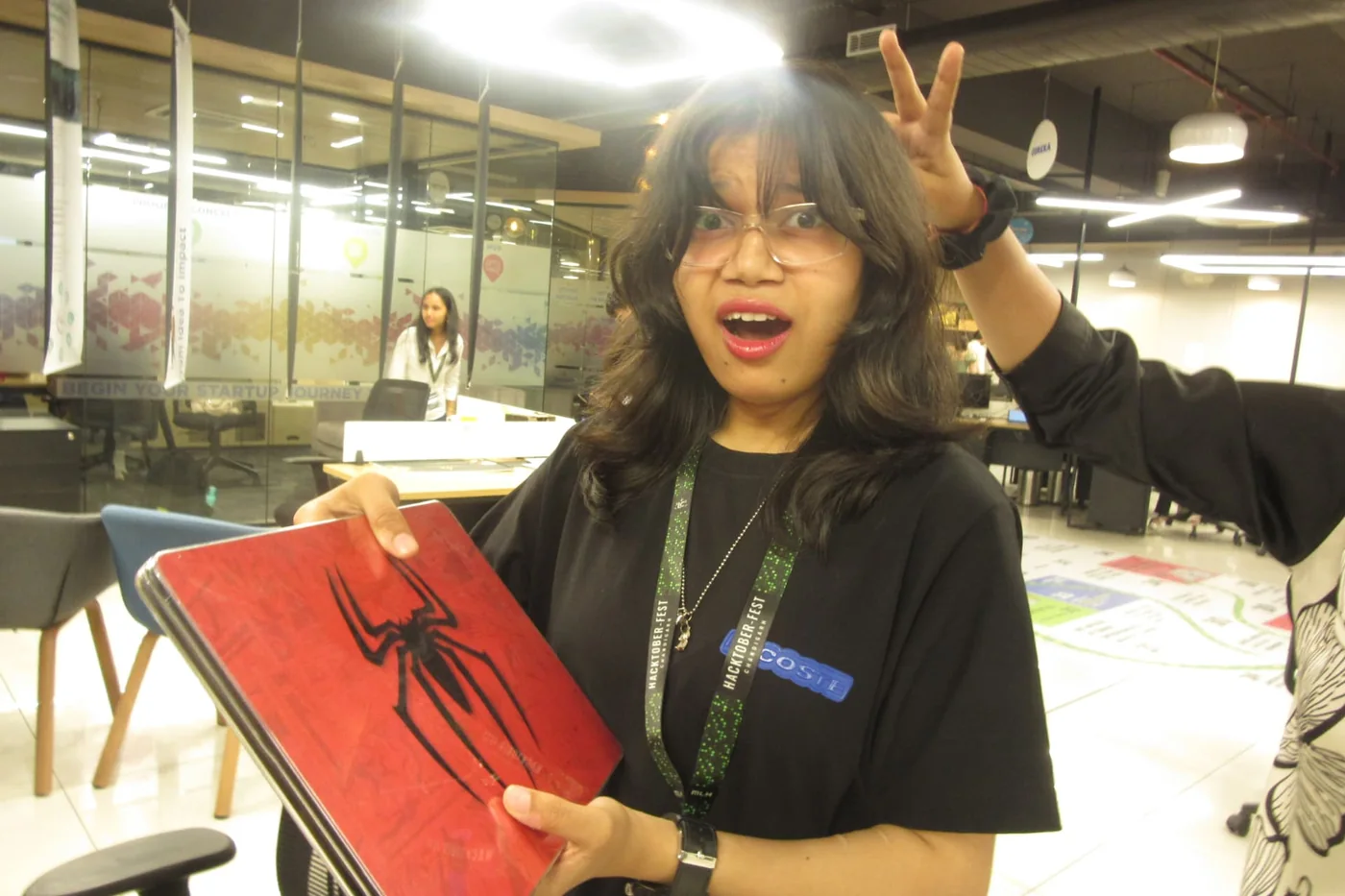 A hacker sharing a playful moment with a laptop